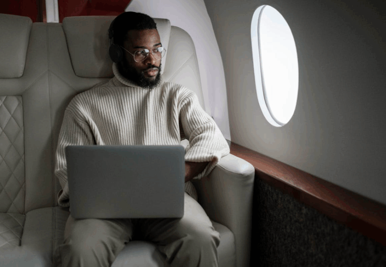 man with device on airplane